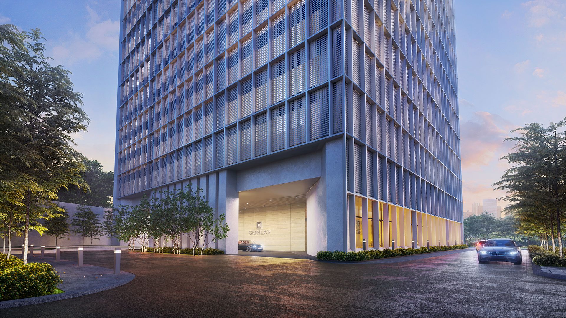 The fin-lined facade at the arrival court, dusk
