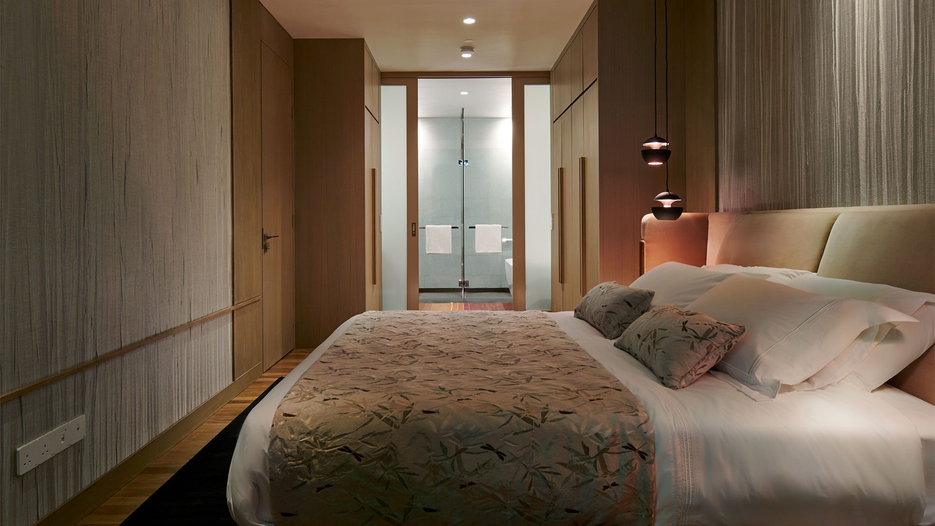 A bedroom in the Type D show unit, with the balcony beyond